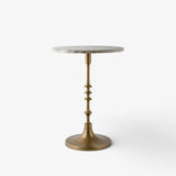 French Country Collections Side table at Cerise.  featuring a veined marble top in natural with a brass coloured metal pedestal base.