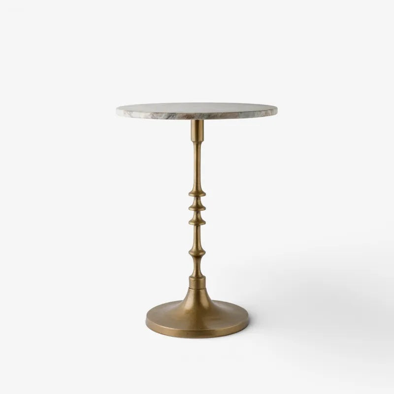 French Country Collections Side table at Cerise.  featuring a veined marble top in natural with a brass coloured metal pedestal base.