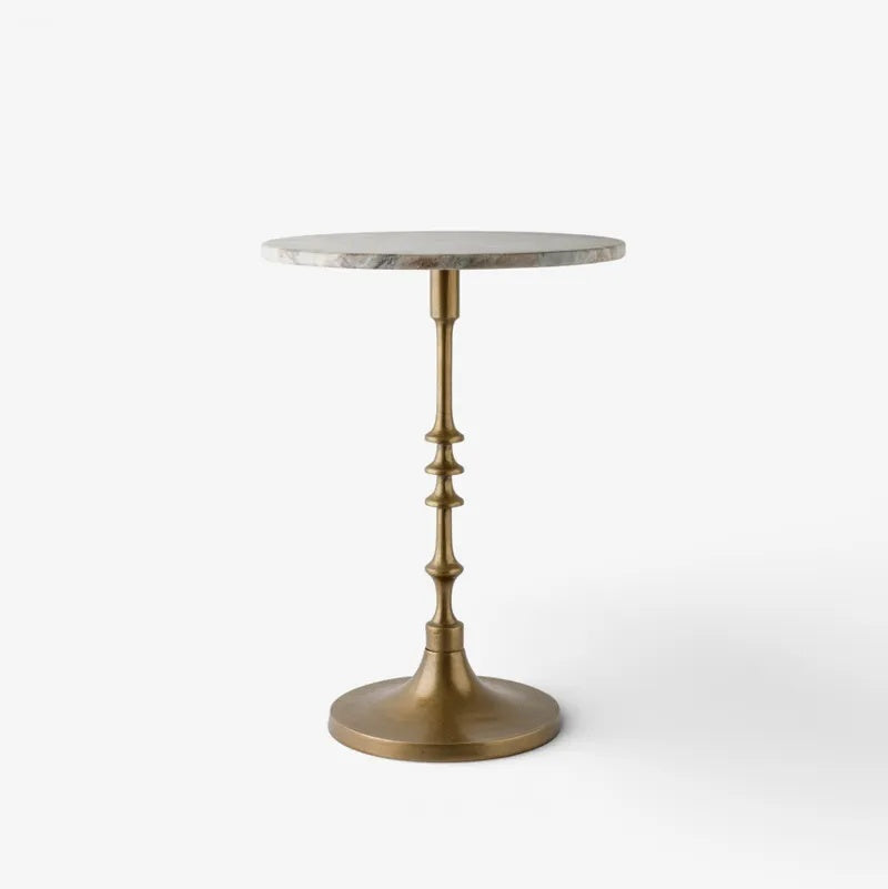 French Country Collections Side table at Cerise.  featuring a veined marble top in natural with a brass coloured metal pedestal base.