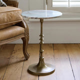Elevate your living space with the Sutton Side Table from French Country at Cerise. Featuring a timeless antique gold metal base paired with a beautifully veined natural marble top in warm, earthy tones. Blending classic elegance with contemporary style, this versatile piece is perfect beside a sofa, armchair, or bed.