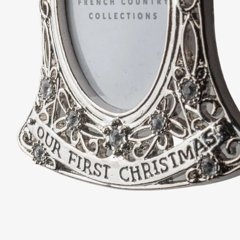 French Country baby’s first Christmas hanging photo frame ornament at Cerise. Featuring an elegant bell shape with delicate detailing and crystal-style accents, it holds a small photo and hangs from a ribbon—perfect for a Christmas tree or nursery keepsake. 
Measures  7.1cmLx9cmWx0.5cmH