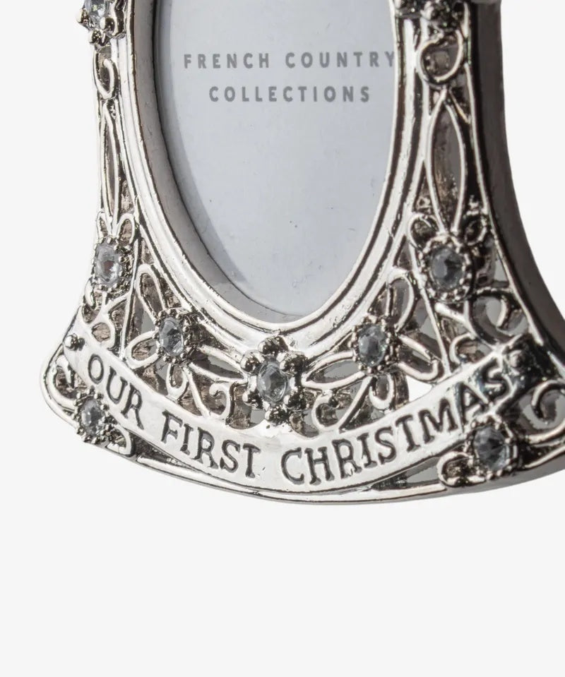 French Country baby’s first Christmas hanging photo frame ornament at Cerise. Featuring an elegant bell shape with delicate detailing and crystal-style accents, it holds a small photo and hangs from a ribbon—perfect for a Christmas tree or nursery keepsake. 
Measures  7.1cmLx9cmWx0.5cmH