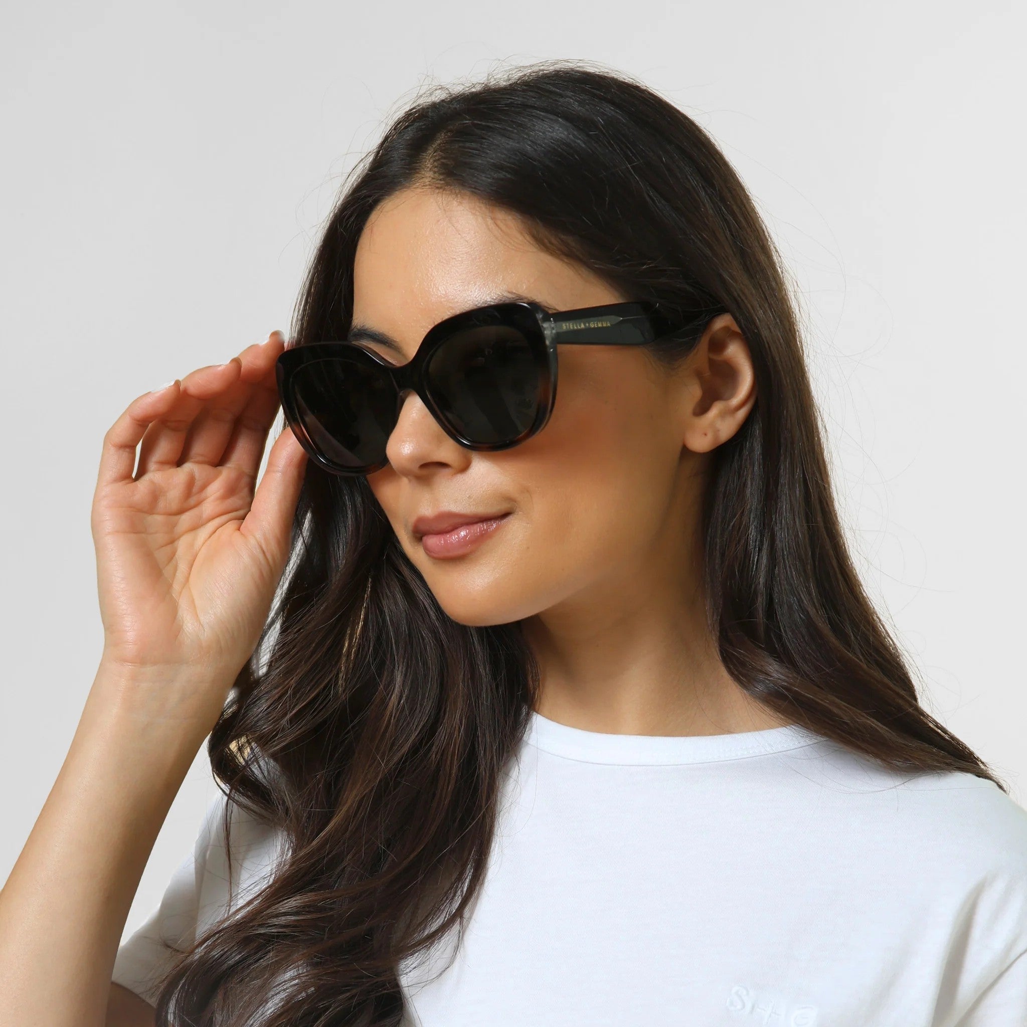 Woman wearing transparent tort coloured sunglasses