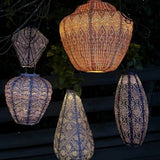 Group of lumiz lanterns in purple and apricot colours at night time
