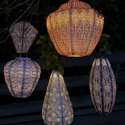 Group of lumiz lanterns in purple and apricot colours at night time