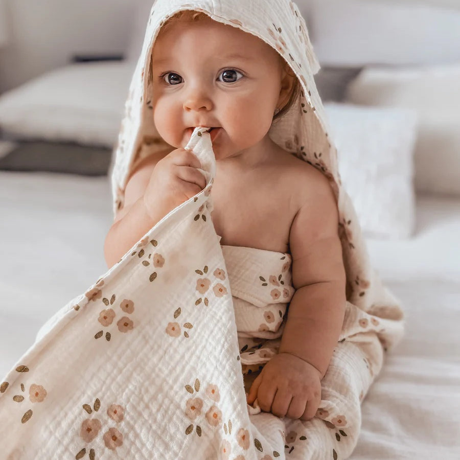 Over the Dandelions Hooded Towel in Daisy Print at Cerise. Made from super soft cotton muslin, has a hood and plenty of wrap for baby.