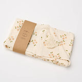 Over the Dandelions Hooded Towel in Daisy Print at Cerise. Made from super soft cotton muslin, has a hood with tassle and plenty of wrap for baby.