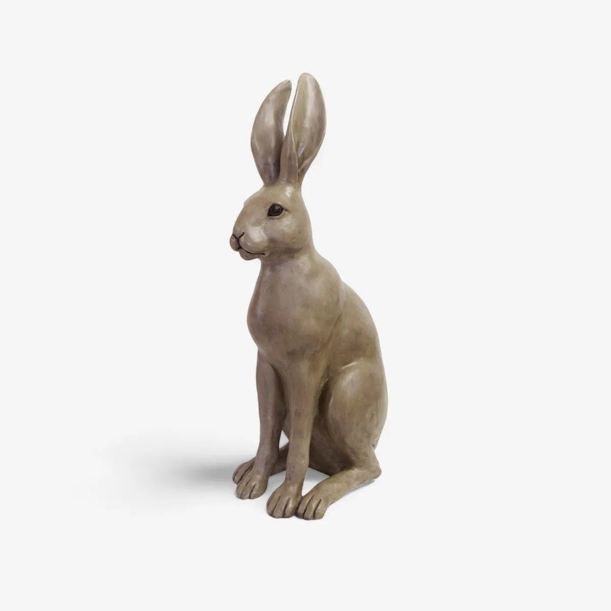 Statue of a sitting brown hare on a white background