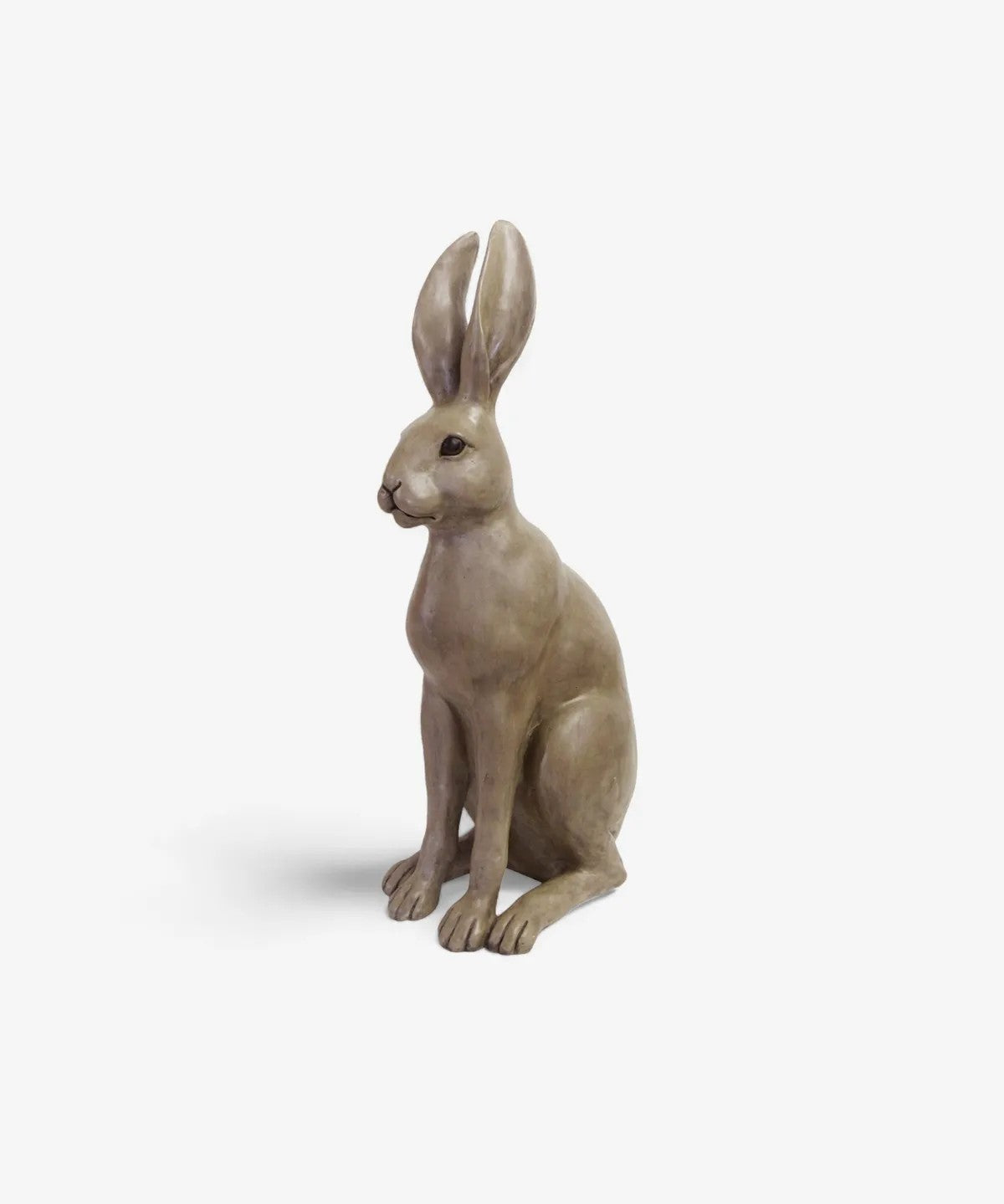 Statue of a sitting brown hare on a white background