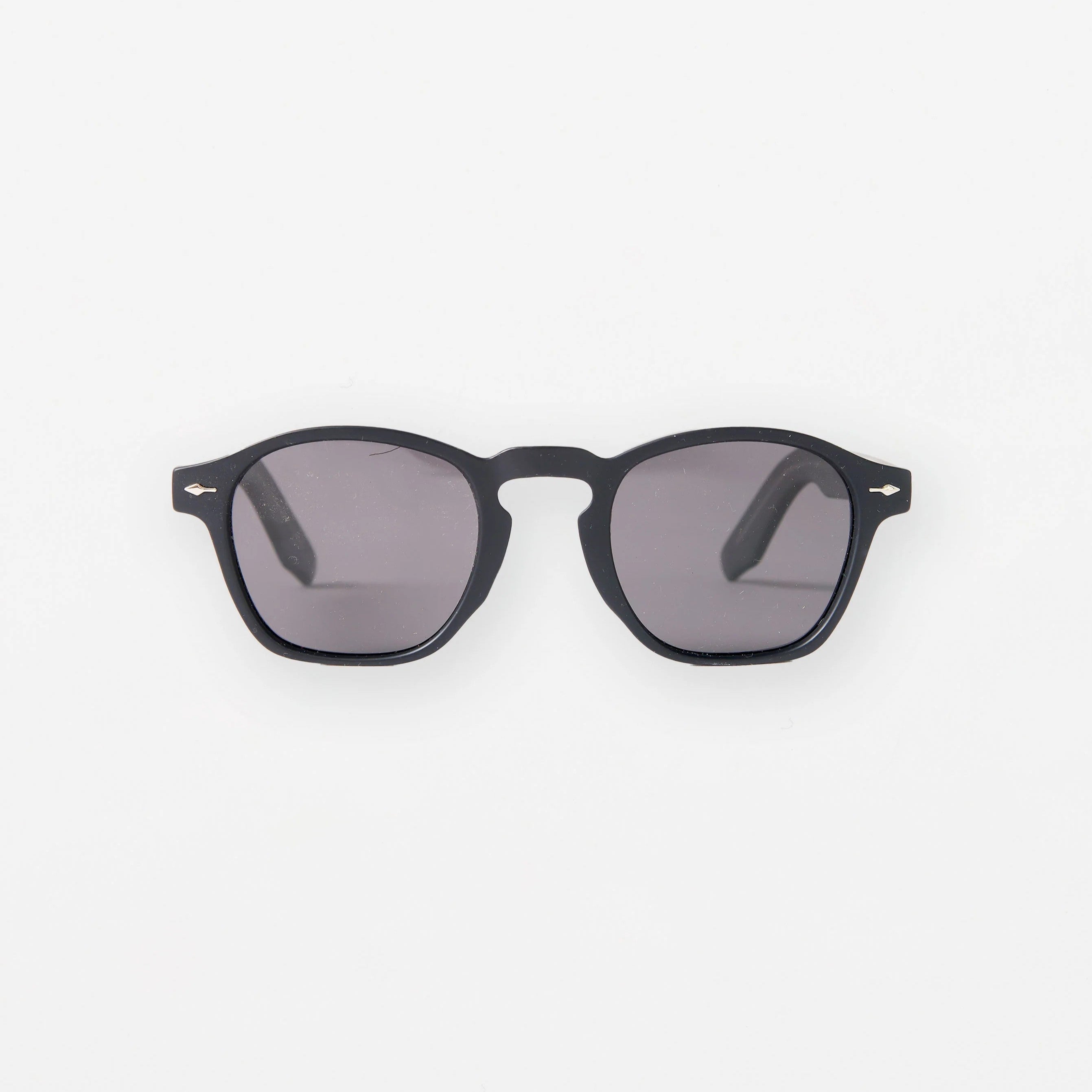 Black sunglasses with dark lenses on a white background
