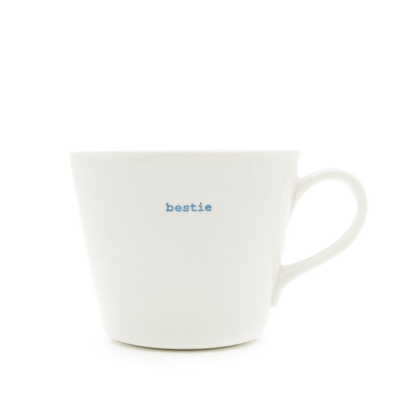 White mug with 'bestie' text in blue on a white background
