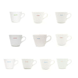 Set of white mugs with colorful text on a white background