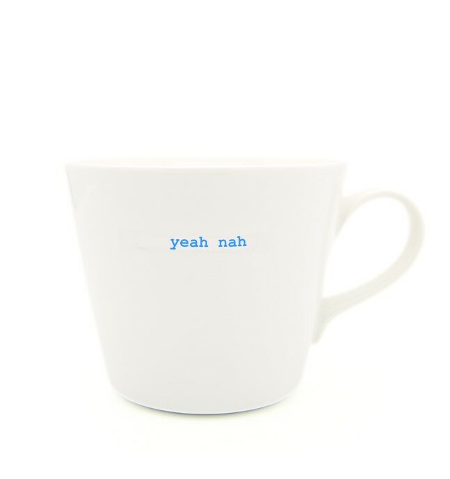 White mug with 'yeah nah' text in blue on a white background