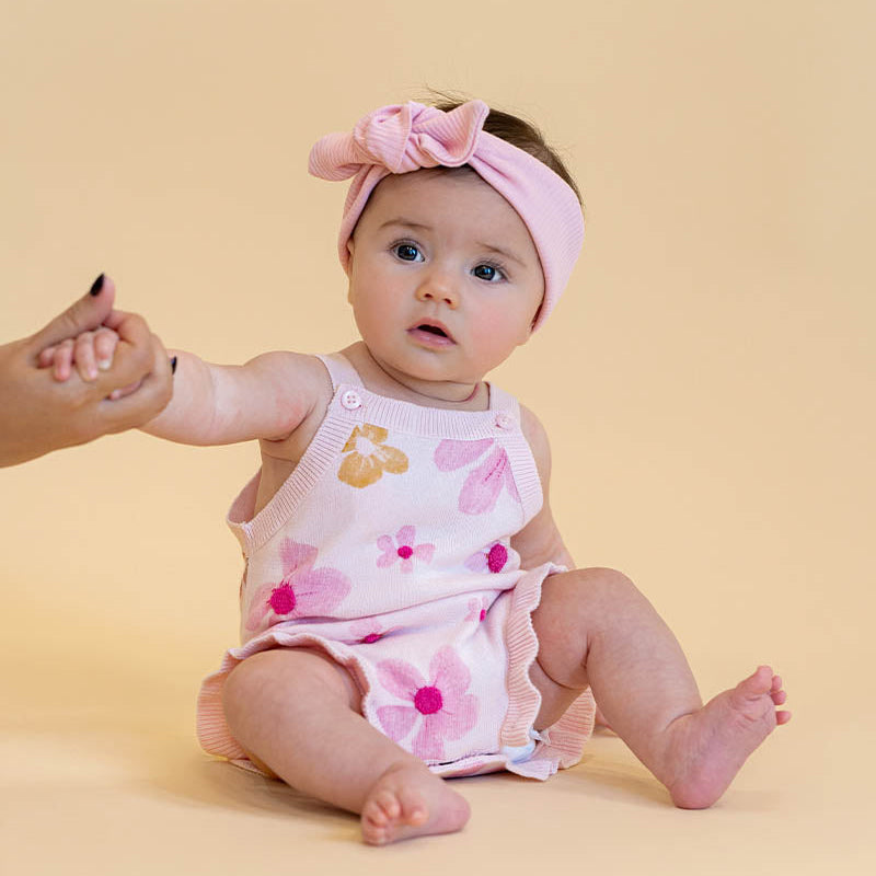 cotton knit romper with floral print design with boucle embroidery, soft pink base and sweet frill trims,