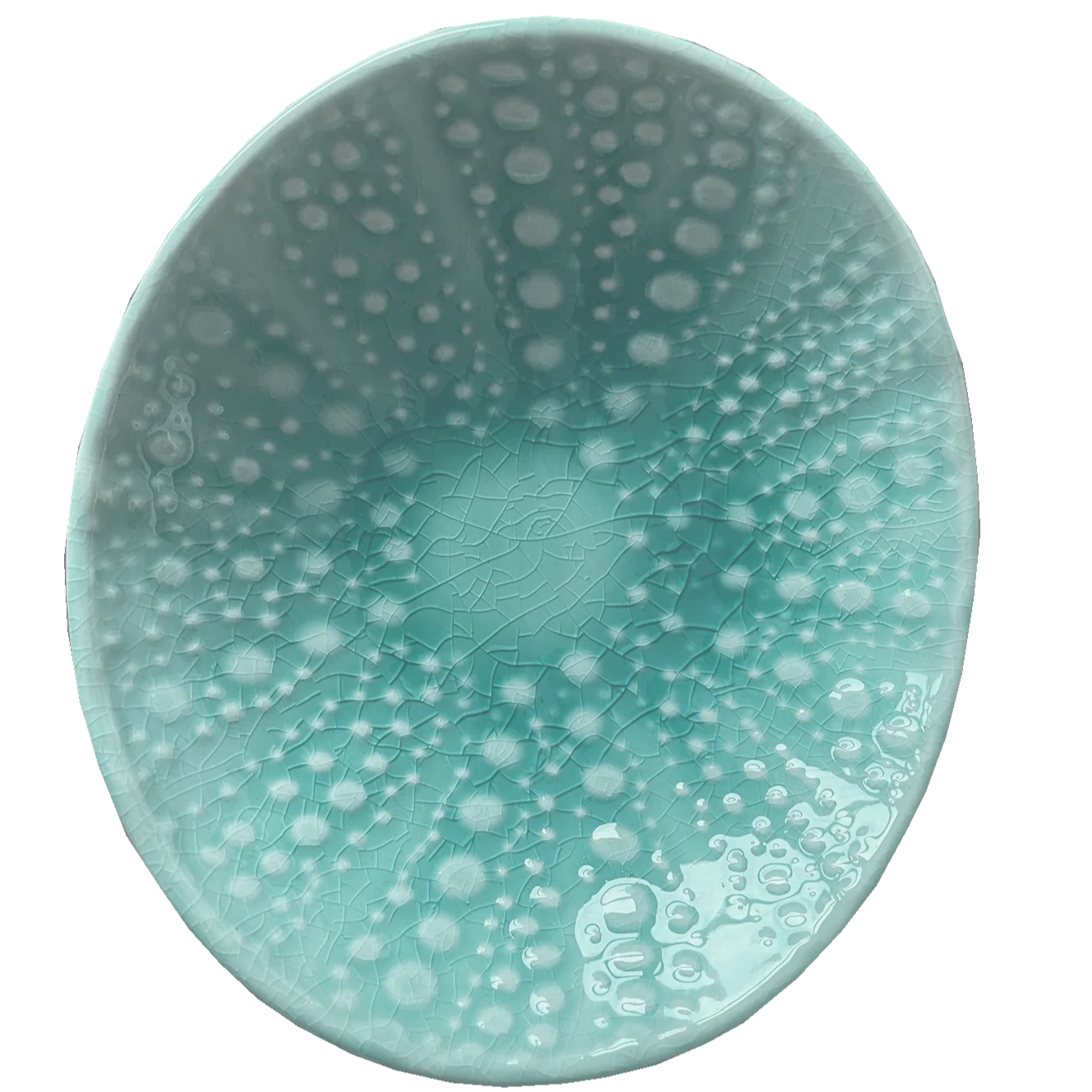 Teal ceramic bowl with white speckled pattern on a white background