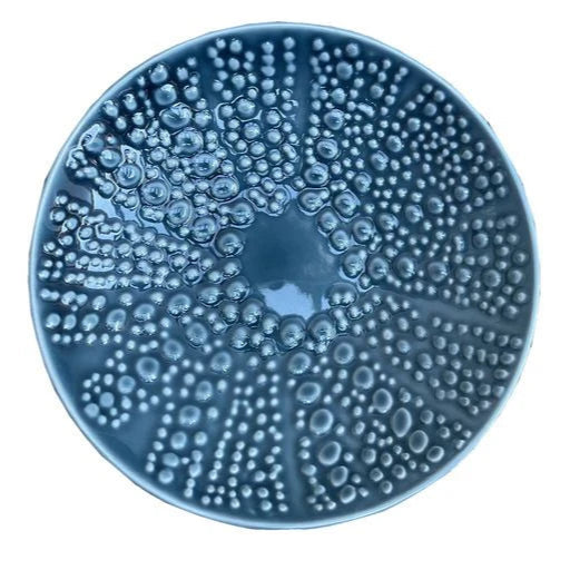Blue kina ceramic bowl with bubble pattern on a white background