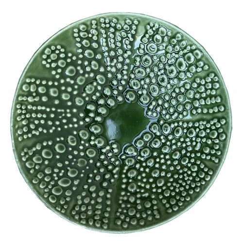 Green kina ceramic bowl with bubble pattern on a white background