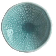 Aqua kina ceramic bowl with bubble pattern on a plain background