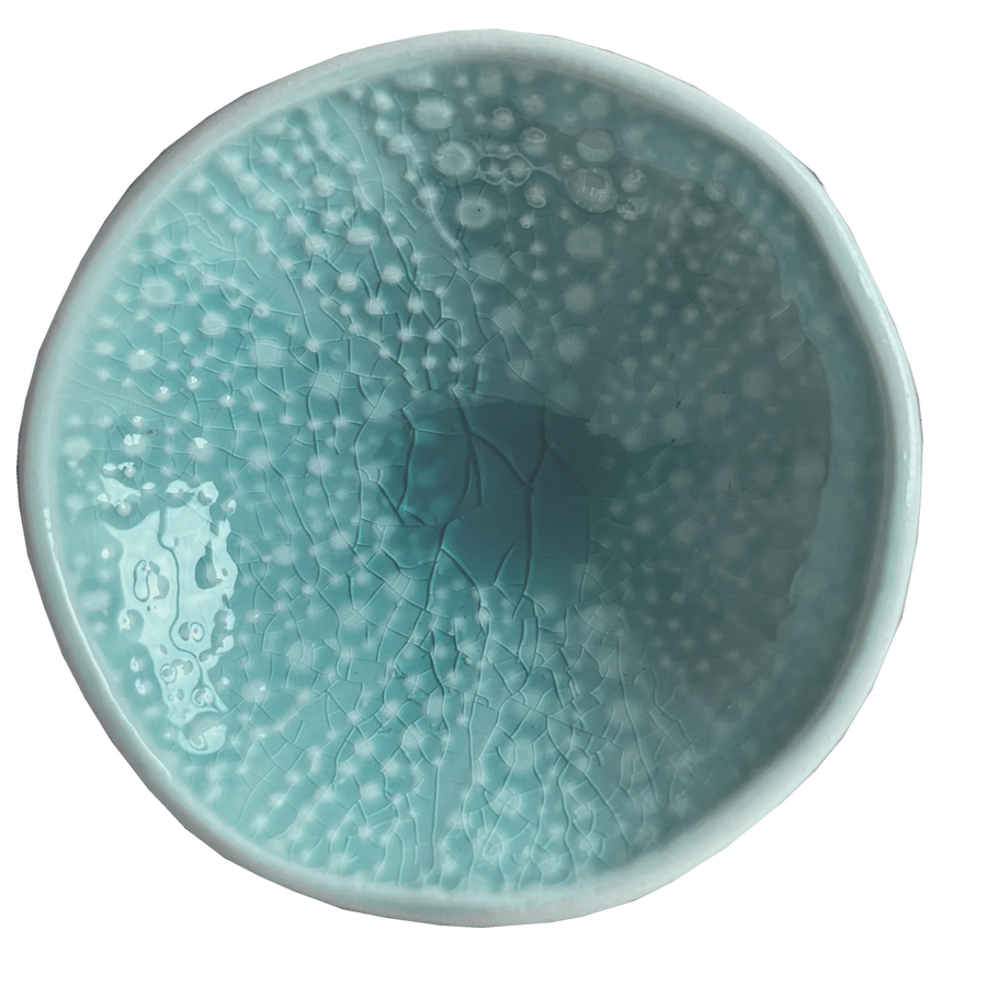 Aqua kina ceramic bowl with bubble pattern on a plain background