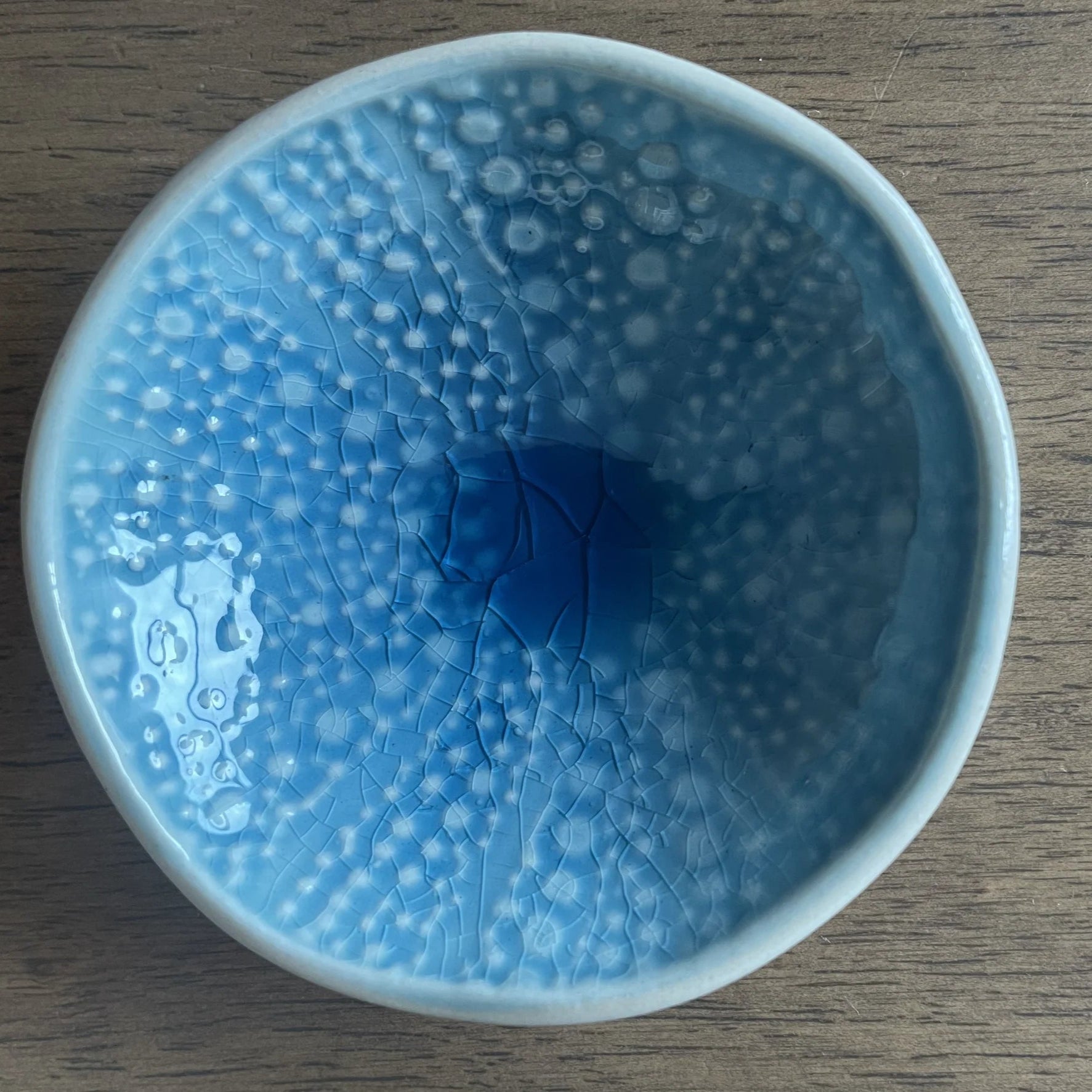 Blue kina ceramic bowl with bubble pattern on a white background