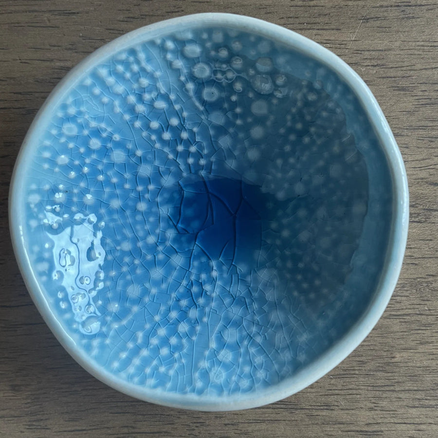 Blue kina ceramic bowl with bubble pattern on a white background