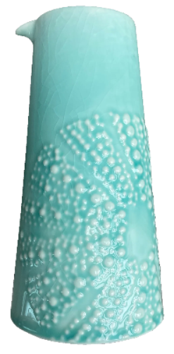 Aqua ceramic kina jug with white bubble texture on a white background