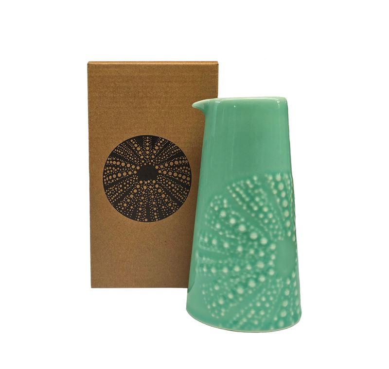 Aqua coloured ceramic handleless jug with embossed kina design