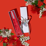 Image of a Pohutakawa Red LIving Light mini icicle candle in a white gift box.