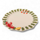 Close-up of raised red lobster, citrus wedge and tomato details on stoneware dinner plate at Cerise