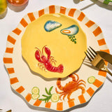 Yellow stoneware lobster plate styled for coastal dining and summer entertaining available at Cerise NZ