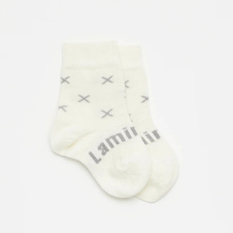 Lamington Newborn naturals merino socks in  Fox design at Cerise. Feature grey crosses on a white backround