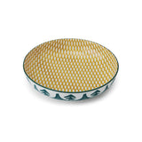 Decorative bowl with yellow pattern on green  and white tree pattern outside white background