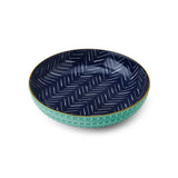 Navy ceramic bowl with white zigzag pattern on a white background