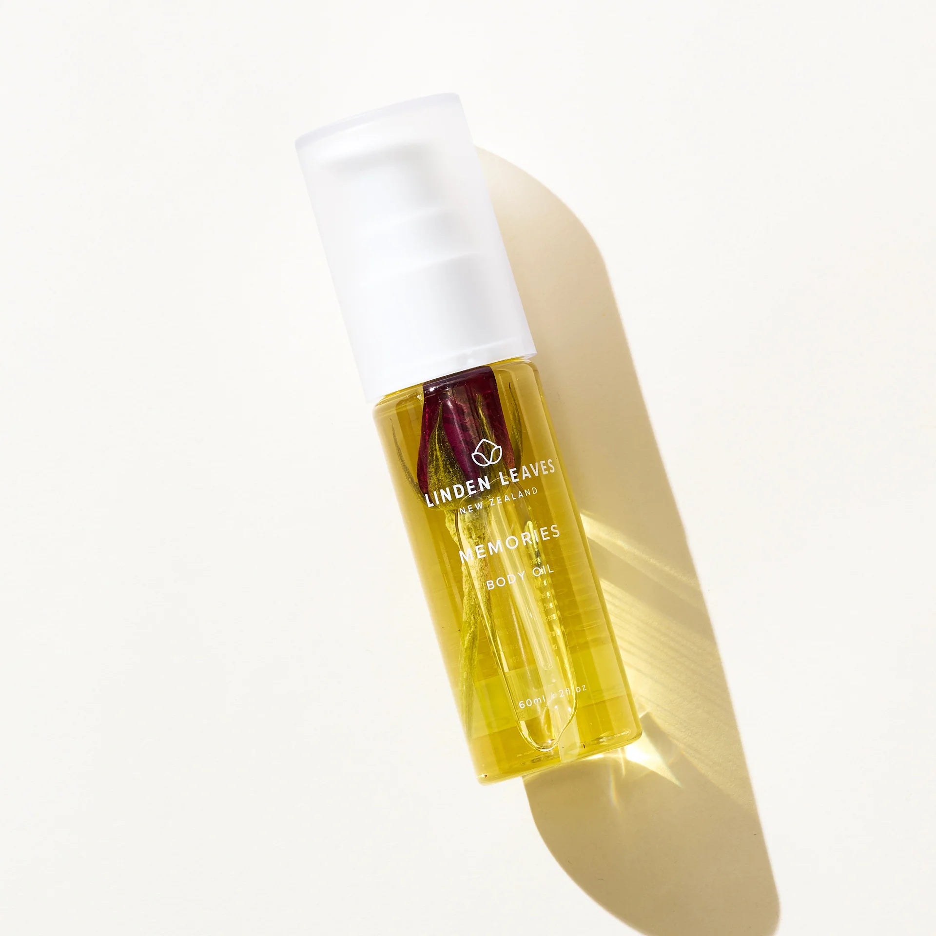 Linden Leaves 60ml pum bottle body oil at Cerise in our beautiful In Memories Fragrance, infused with a red rose bud aand New Zealand made.