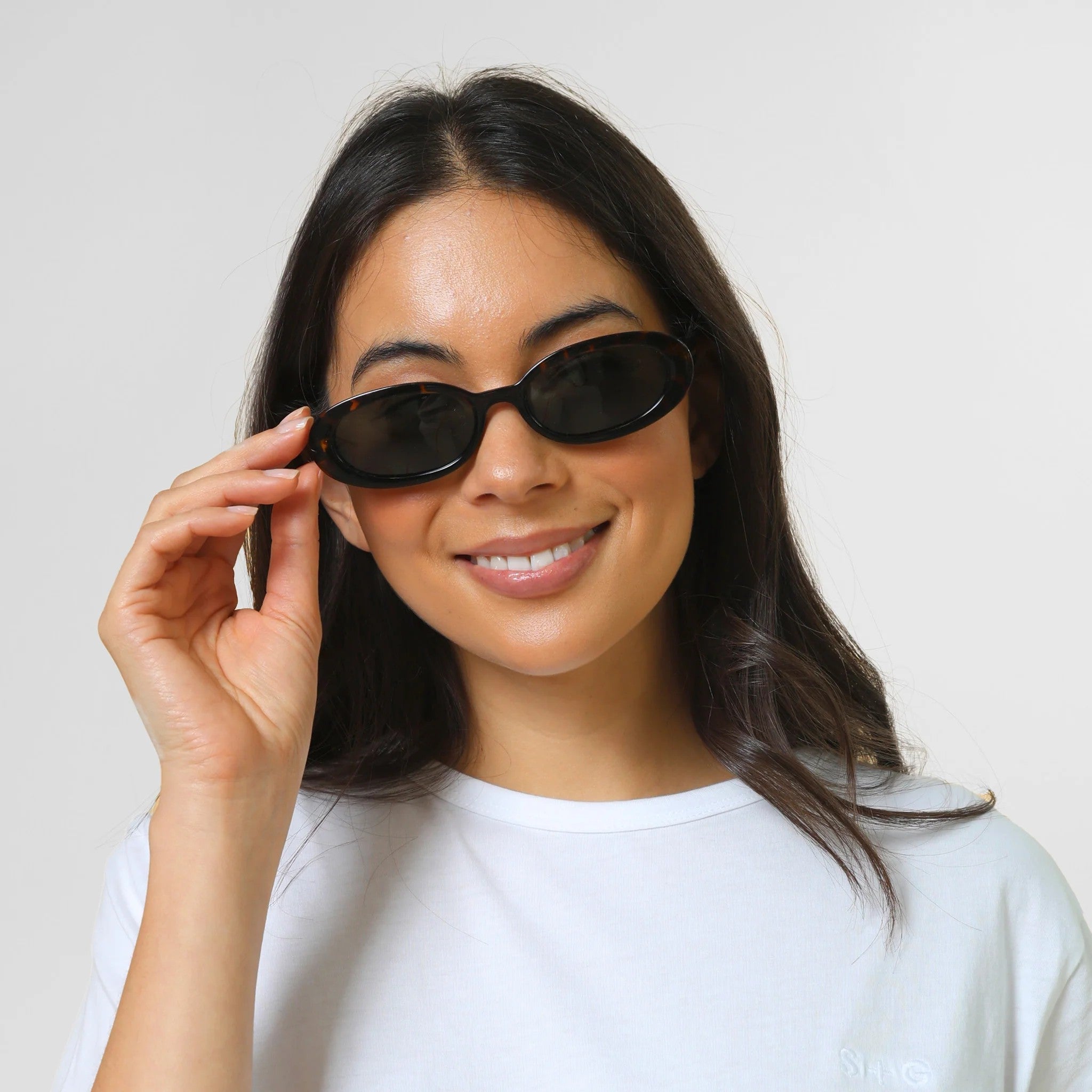 Girl wearing Tortoise Shell coloured oval sunglasses