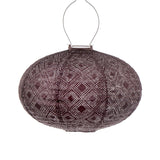 Hanging Lumiz solar lantern in an oval shape and made of plum coloured tyvek material.  Features a stunning mosaic pattern creating a gorgeous silhouette on the ground as dusk falls at Cerise