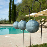 A concept picture of three hanging Lumiz solar lanterns in grey blue colour.  They are round in shape measuring 20cm ahd have the folia design pattern at Cerise