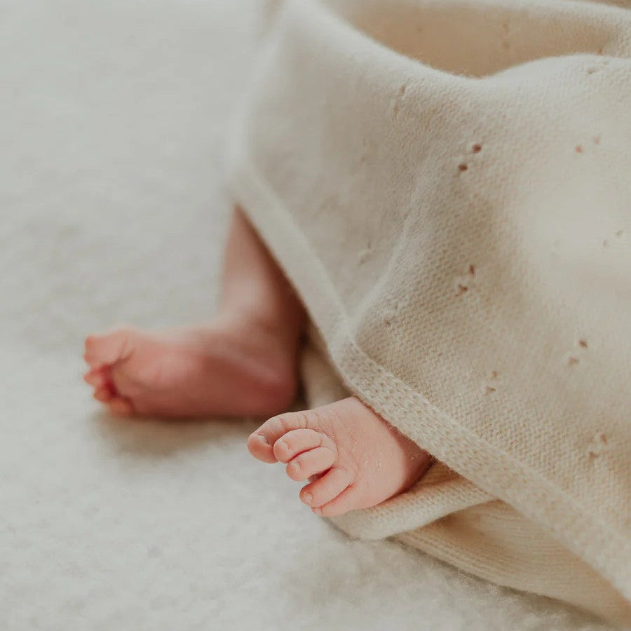 Merino's unique breathable properties help regulate body temperature, keeping baby warm on cooler days while remaining comfortably cool when the weather is warmer. Our merinow wool knitted baby blanket in Ivory is perfect for use in the pram, bassinet, cot, or while cuddling, this versatile blanket is an everyday essential for little ones.