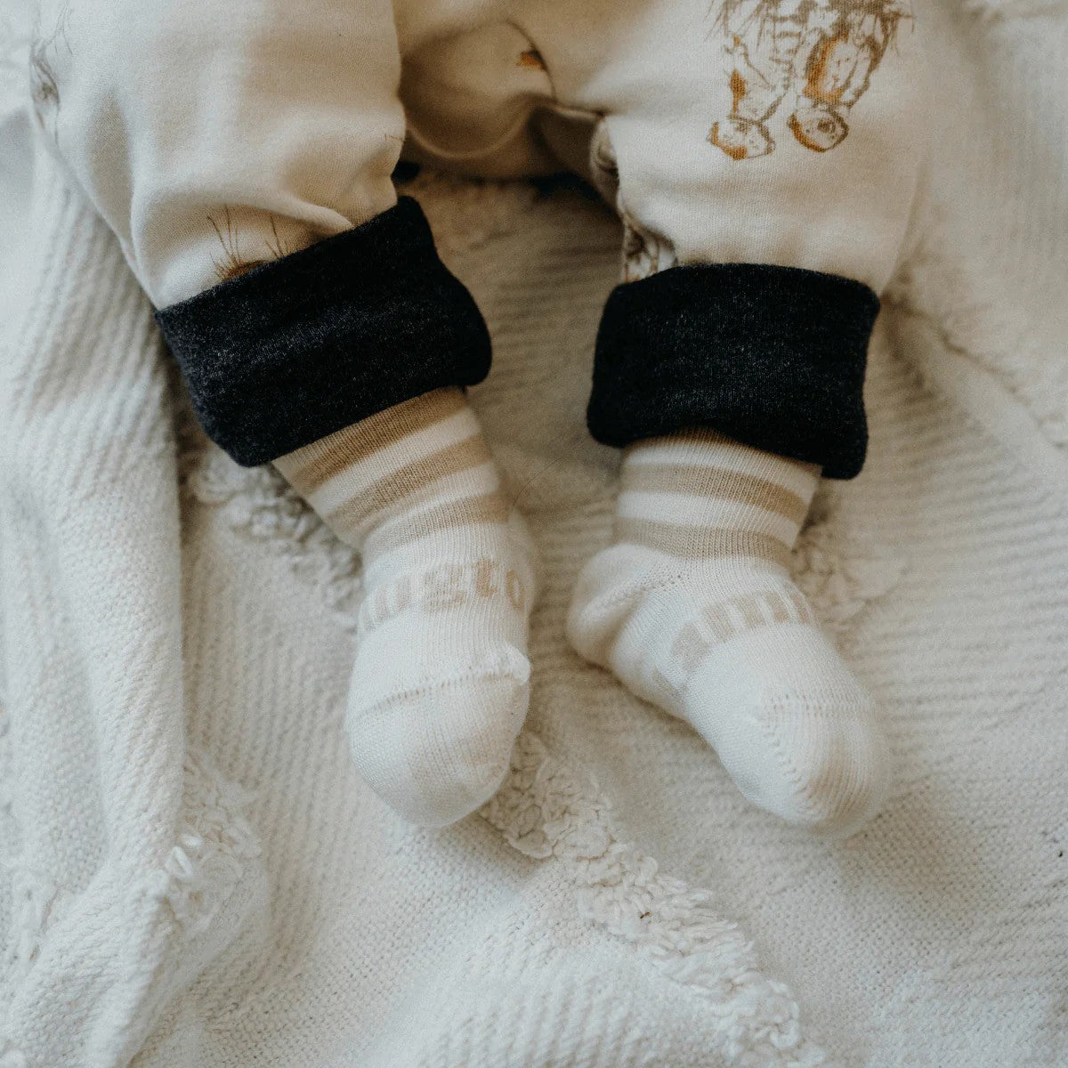 Lamington Merino Baby Socks in Squireel design at Cerise. Features white with oatmeal stripe for newborn baby gift.