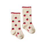 Pair of cream socks with red raspberry pattern on a white background
