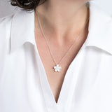 Model wearing a Silver necklace with a 45cm chain and a NZ Manuka Flower Pendant
