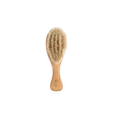 Nature Baby Hairbrush at Cerise.  Made from sustainable wood and goats har bristles for softness on babies dilicate hair.   A practical newborn baby gift.
