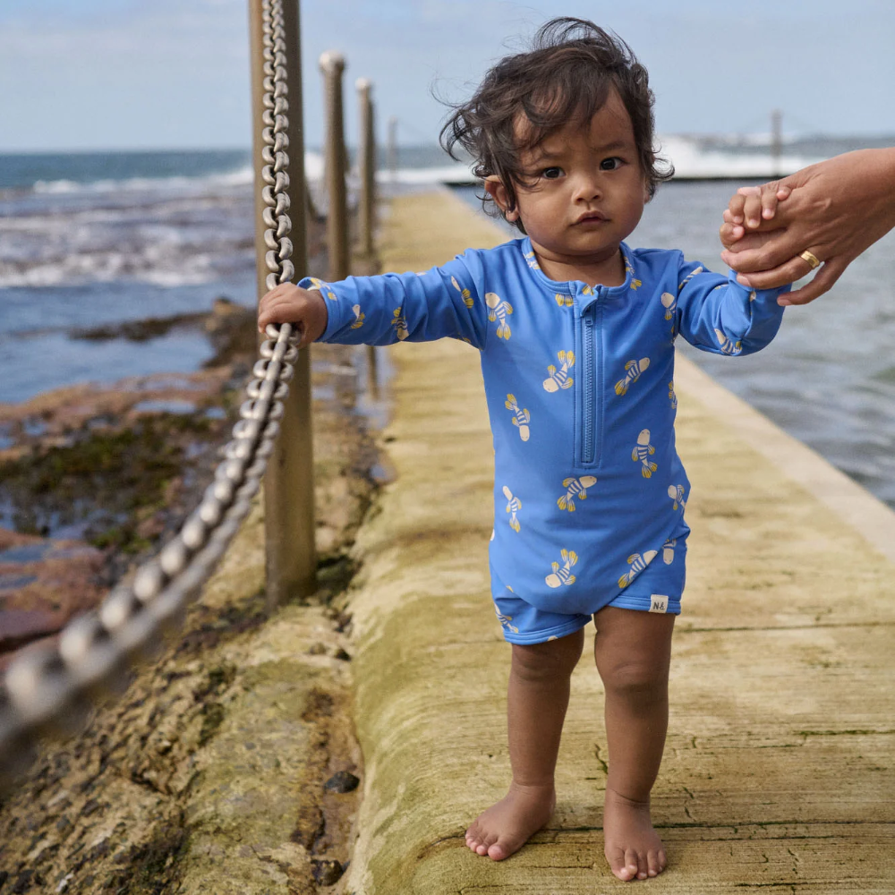 Nature Baby One Piece Bathing Trunks in Fish Fable Design at Cerise.  A great unisex design with lined body for comfort, protection from the sun for sunny days and water play