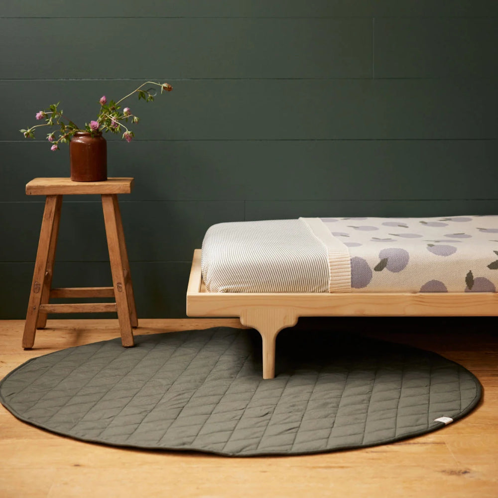 Nature Baby Quilted playmat in round design at Cerise.  Practical round shape in stunning green thyme colour.