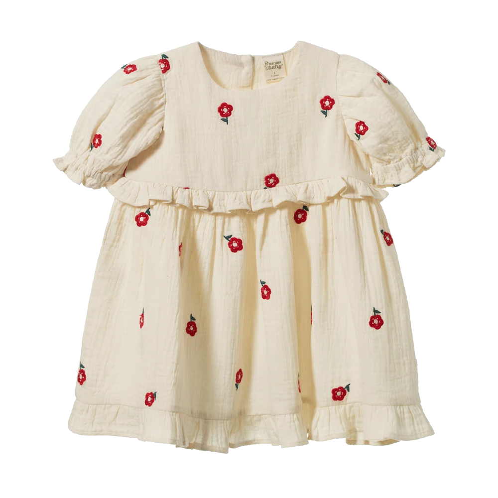 Nature Baby Valentina Dress in Red Flora at Cerise.  Made of muslin and features red embroidered flowers on a natural background.  Stunning puffed sleeves and frill at the waist and hemline.