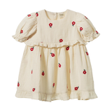 Nature Baby Valentina Dress in Red Flora at Cerise.  Made of muslin and features red embroidered flowers on a natural background.  Stunning puffed sleeves and frill at the waist and hemline.