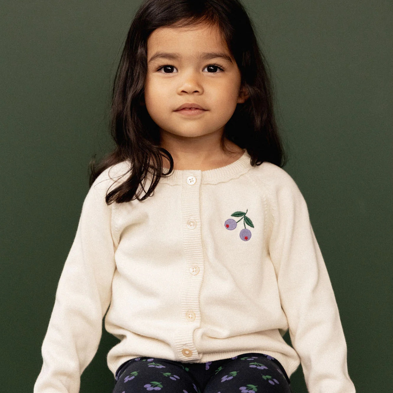 Nature Baby Piper cardigan in an off white colour with a berry print on the top front