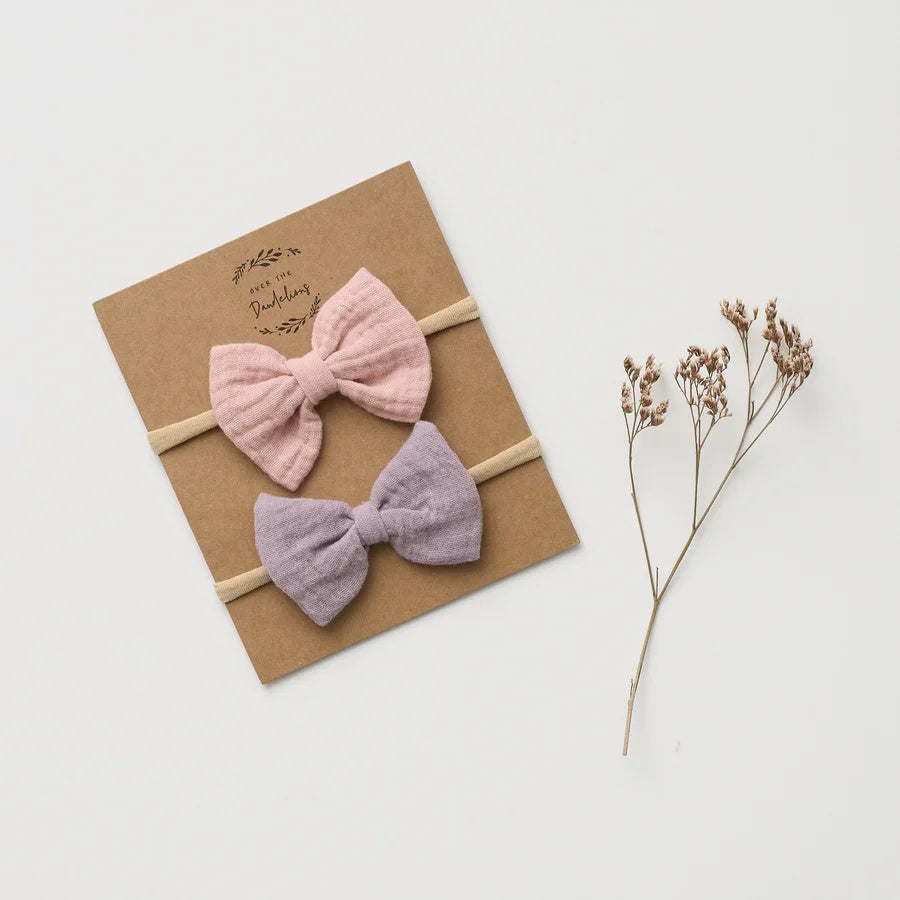 Over the Dandelions Muslin Bow Headbands at Cerise. Set of 2 in Lilac and Blush.