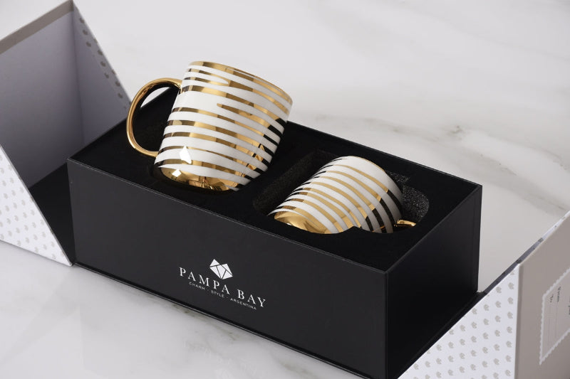 Two gold and white striped mugs in a black Pampa Bay box 