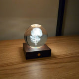 Crystal ball light with laser engraved phohutukawa flower.